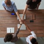 photo of people doing fist bump